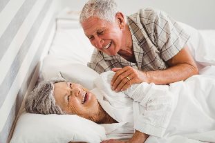 Elderly couple lying in bed